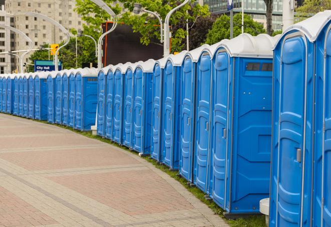 a row of portable restrooms set up for a large athletic event, allowing participants and spectators to easily take care of their needs in Garrison, ND